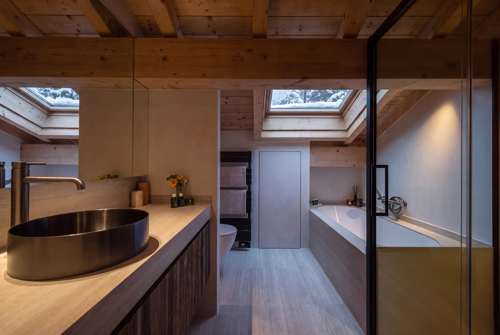 Master bathroom with stone basin and skylight
